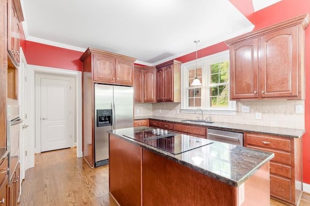 kitchen with stainless steel appliances, backsplash, light wood-style floors, a sink, and dark stone countertops