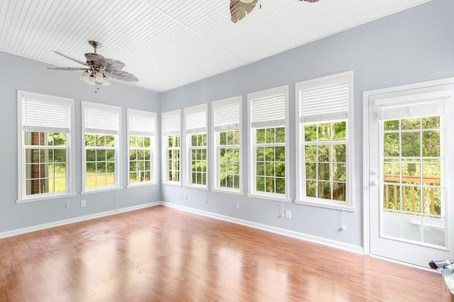 unfurnished sunroom with ceiling fan