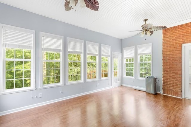 unfurnished sunroom with ceiling fan and a healthy amount of sunlight