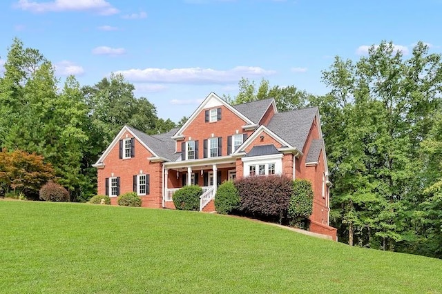 view of front of house featuring a front yard and covered porch