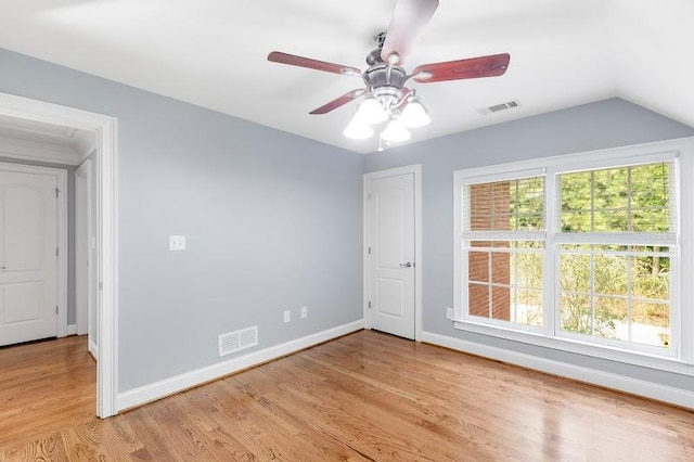 unfurnished room featuring light wood-type flooring, baseboards, visible vents, and a ceiling fan