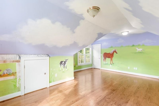 bonus room featuring vaulted ceiling, wood finished floors, and baseboards