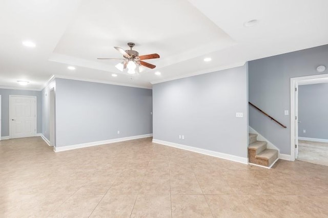 unfurnished room with recessed lighting, a ceiling fan, baseboards, stairs, and a tray ceiling