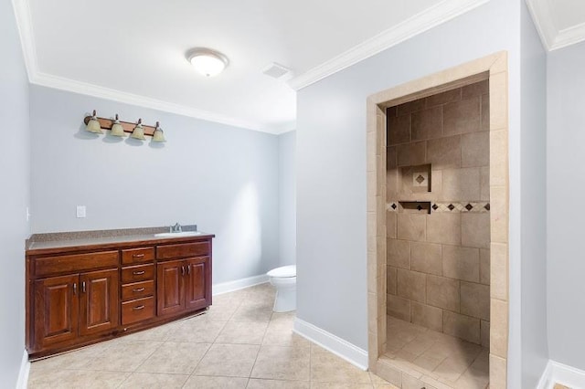 bathroom featuring ornamental molding, tiled shower, vanity, tile patterned flooring, and toilet