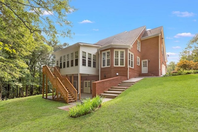 back of house featuring a sunroom and a yard