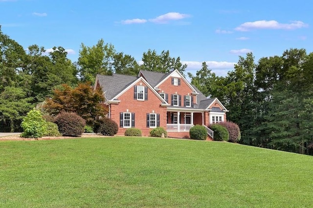 view of front of property with a front yard and covered porch