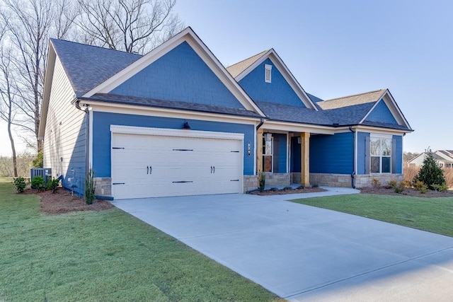 craftsman house with cooling unit, a garage, and a front lawn