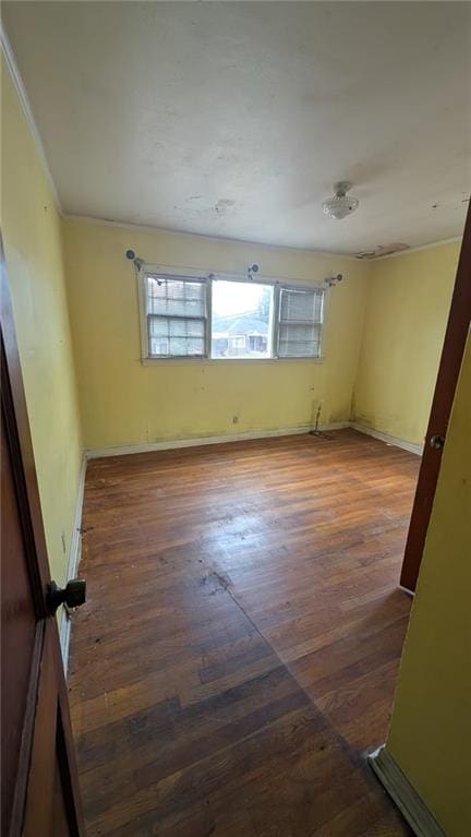 empty room with dark hardwood / wood-style flooring