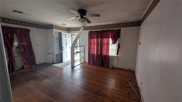 spare room featuring dark wood-type flooring and ceiling fan