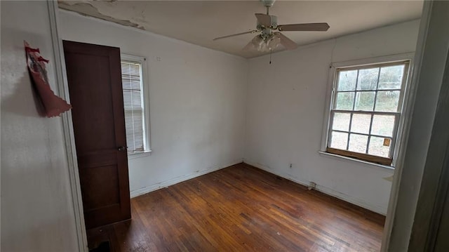 spare room with dark wood-type flooring and ceiling fan