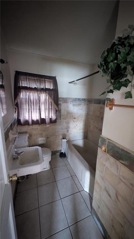 bathroom featuring tile patterned floors, toilet, and sink