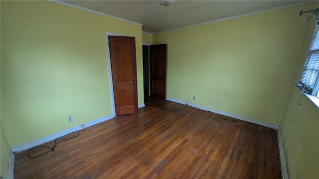 unfurnished bedroom with ornamental molding and dark hardwood / wood-style floors