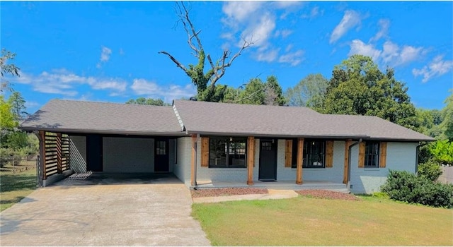 ranch-style house featuring a carport and a front lawn