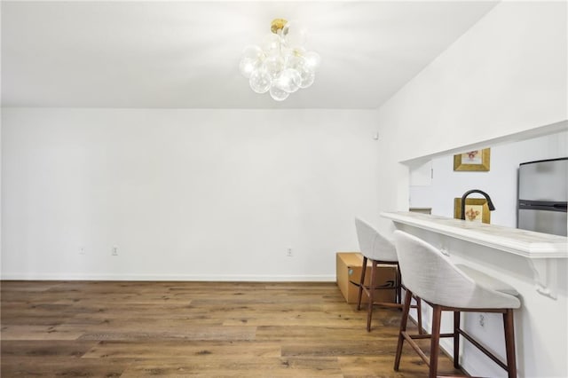 office area with hardwood / wood-style flooring, sink, and an inviting chandelier