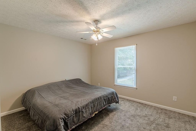 bedroom featuring a textured ceiling, carpet flooring, and ceiling fan