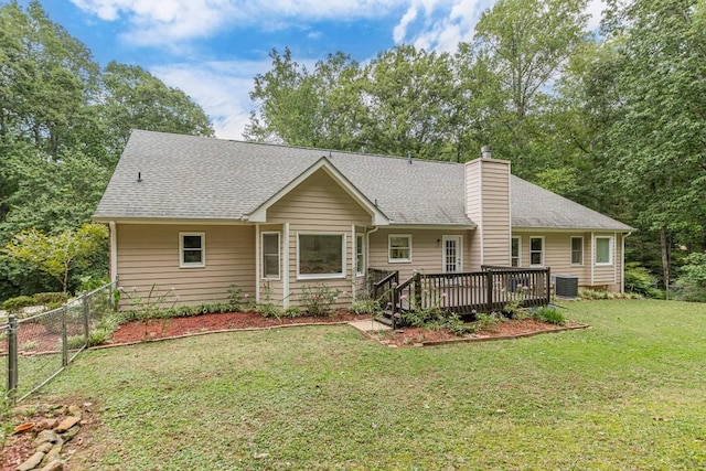 ranch-style home featuring cooling unit, a wooden deck, and a front yard