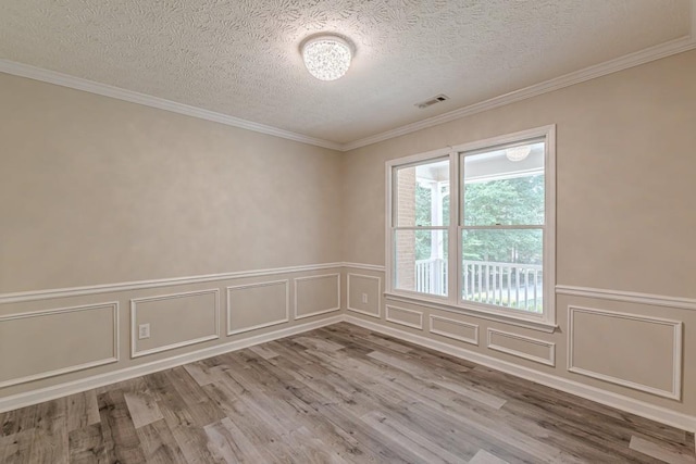 unfurnished room featuring ornamental molding and light hardwood / wood-style floors