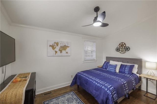 bedroom with visible vents, ornamental molding, ceiling fan, wood finished floors, and baseboards