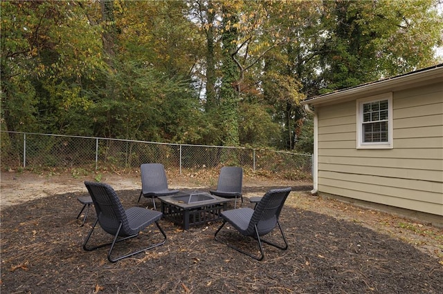 view of patio with an outdoor fire pit and a fenced backyard