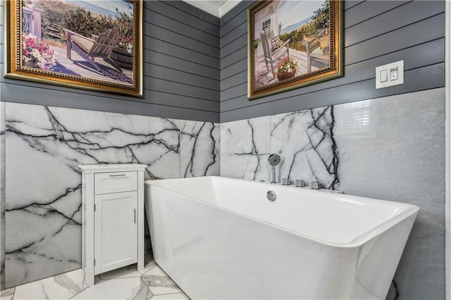 full bathroom featuring a freestanding tub and marble finish floor