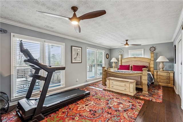 bedroom featuring hardwood / wood-style floors, crown molding, baseboards, and visible vents