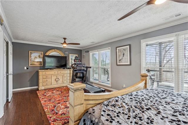 bedroom with dark wood-type flooring, baseboards, visible vents, and ornamental molding