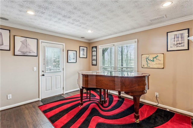 office area featuring visible vents, ornamental molding, baseboards, and wood-type flooring