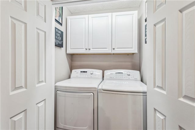 clothes washing area with cabinet space and separate washer and dryer