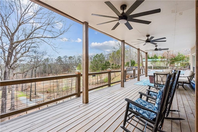 wooden deck with outdoor dining space and ceiling fan