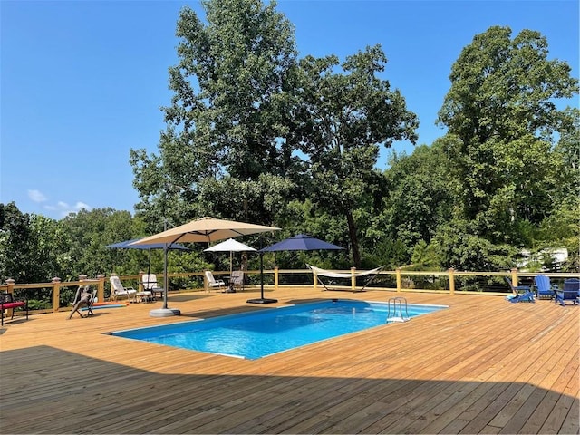 view of swimming pool with a deck