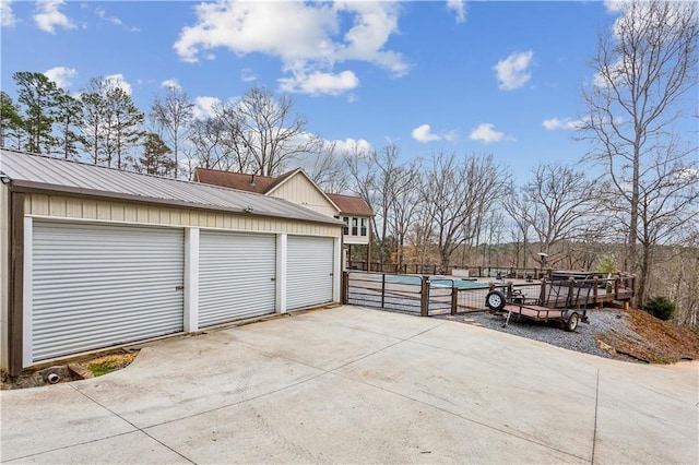 garage featuring a fenced in pool and fence