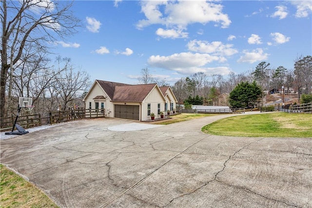 view of home's exterior featuring aphalt driveway, a yard, fence, and board and batten siding