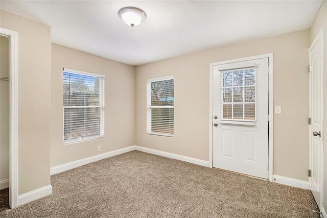 foyer entrance with carpet flooring