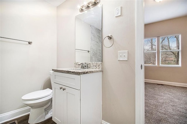 bathroom featuring vanity and toilet