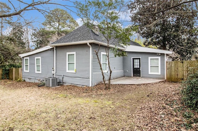 rear view of house featuring central air condition unit and a patio area