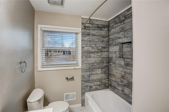 bathroom featuring tiled shower / bath and toilet