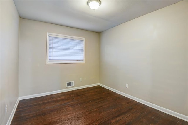 spare room with dark wood-type flooring