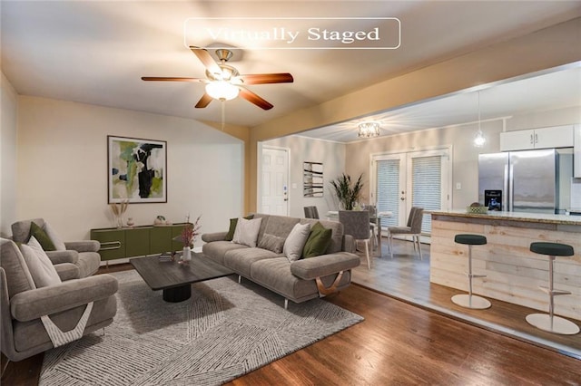 living room featuring ceiling fan, wood-type flooring, and french doors