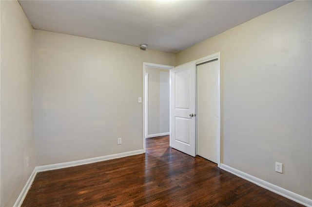 empty room featuring dark wood-type flooring