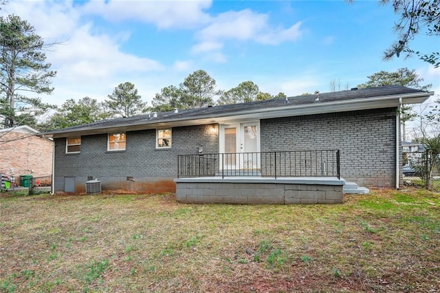 rear view of property with a yard