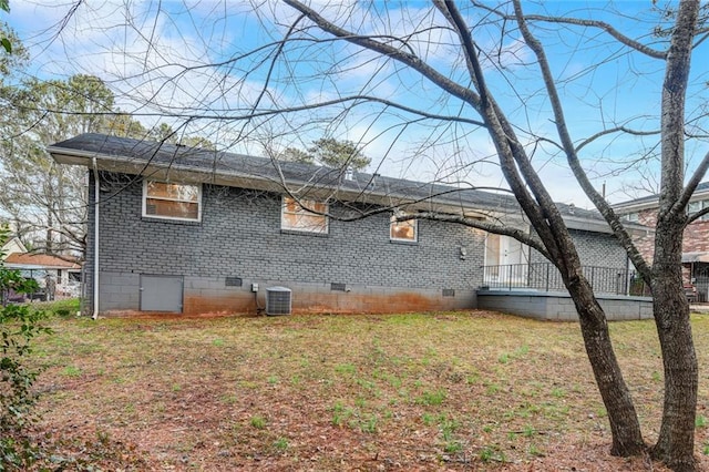 view of property exterior featuring a lawn and central AC