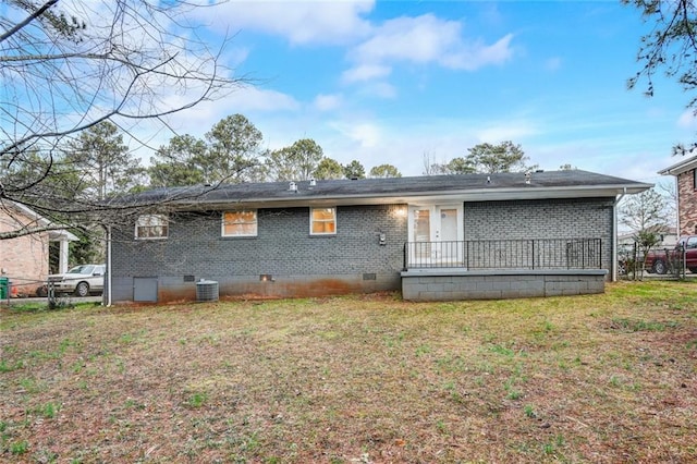 back of house with a yard and central AC