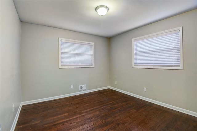 unfurnished room featuring dark hardwood / wood-style floors