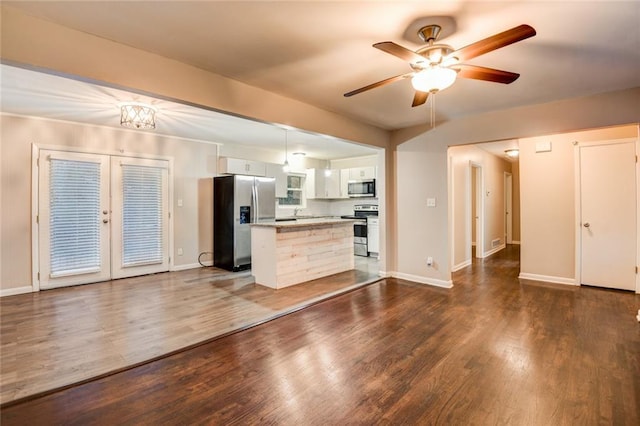 kitchen featuring appliances with stainless steel finishes, dark hardwood / wood-style flooring, french doors, ceiling fan, and white cabinetry