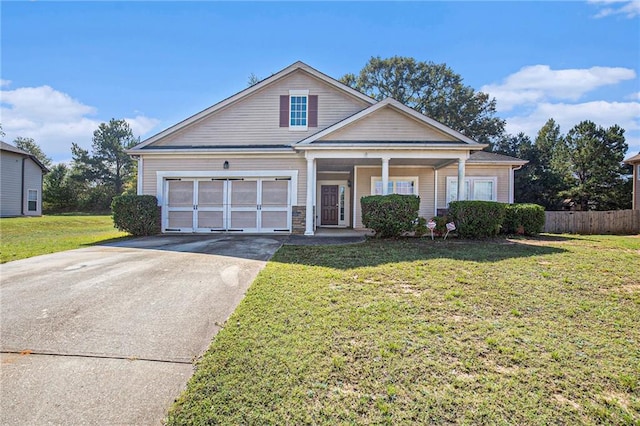 view of front of home with a garage, a porch, and a front lawn