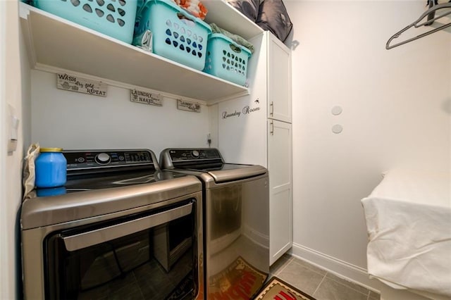 washroom with cabinets, independent washer and dryer, and light tile patterned floors