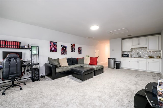 living room featuring sink and light colored carpet