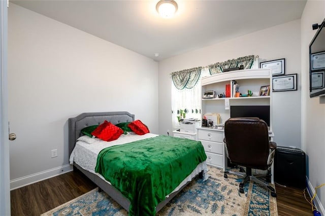 bedroom with dark wood-type flooring