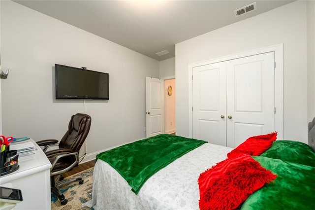bedroom with a closet and hardwood / wood-style flooring