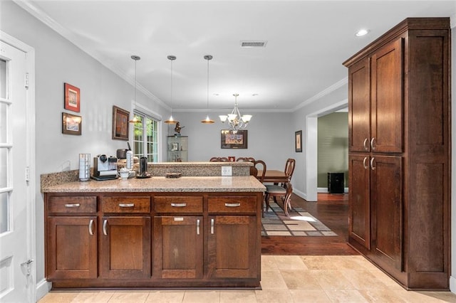 kitchen featuring pendant lighting, ornamental molding, a chandelier, and light hardwood / wood-style floors